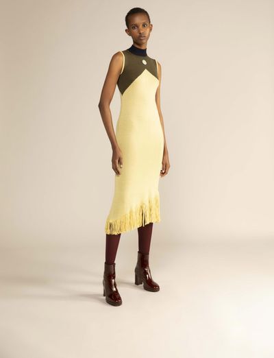 A model wears a Luhkanyo Mdingi olive-green and yellow dress