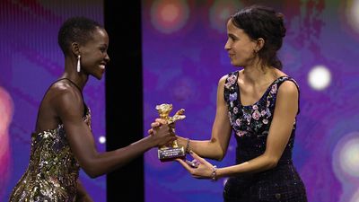 Mati Diop accepts the Golden Bear for Best Film for the film "Dahomey" by President of the International Jury 2024 Lupita Nyong'o on stage at the Award Ceremony of the 74th Berlinale International Film Festival Berlin at Berlinale Palast on February 24, 2024 in Berlin, Germany. 
