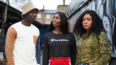 Michaela Coel and the cast of HBO's 'I May Destroy You' standing in a London alley. Wearing streetwear and bucket hat.