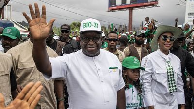 President of Sierra Leone and Leader of Sierra Leone People's party (SLPP), Julius Maada Bio (L), waves to his supporters as he arrives for his final campaign rally in Freetown on June 20, 2023. 