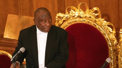 An image of Cyril Ramaphosa standing at a lectern 