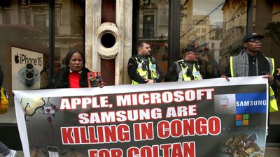 Protesters in London’s Regent Street hold a banner saying “Apple, Microsoft, Samsung Killing in Congo for Coltan” outside the Apple Store during the demonstration on April 6, 2024.