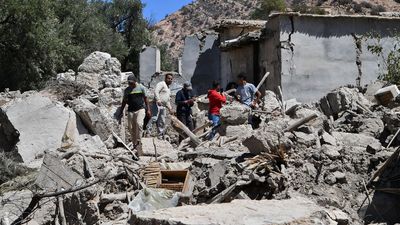 Residents search through the rubble of their homes in Imoulas village of the Taroudant province, one of the most devastated in quake-hit Morocco, on September 11, 2023.