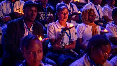 Young Rwandans hold flameless candles while taking part on a vigil during the commemorations of the 30th Anniversary of the 1994 Genocide against the Tutsi at the BK Arena in Kigali on April 7, 2024. 