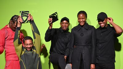 An image of the designers Saul Nash and Mmuso Potsane and Maxwell Boko, standing against a green background, smiling