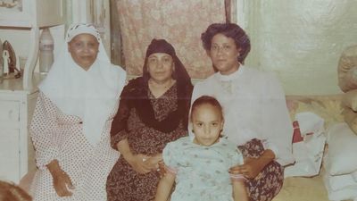 An old family photo of the Tareks in Egypt sitting side by side. 