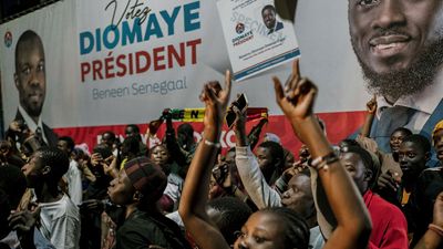 Supporters gather outside anti-establishment candidate Bassirou Diomaye Faye's headquarters in Dakar on March 24, 2024, after voting closed in the presidential election.