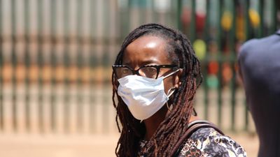 An image of Tsitsi Dangarembga walking outside the magistrate's court in Harare