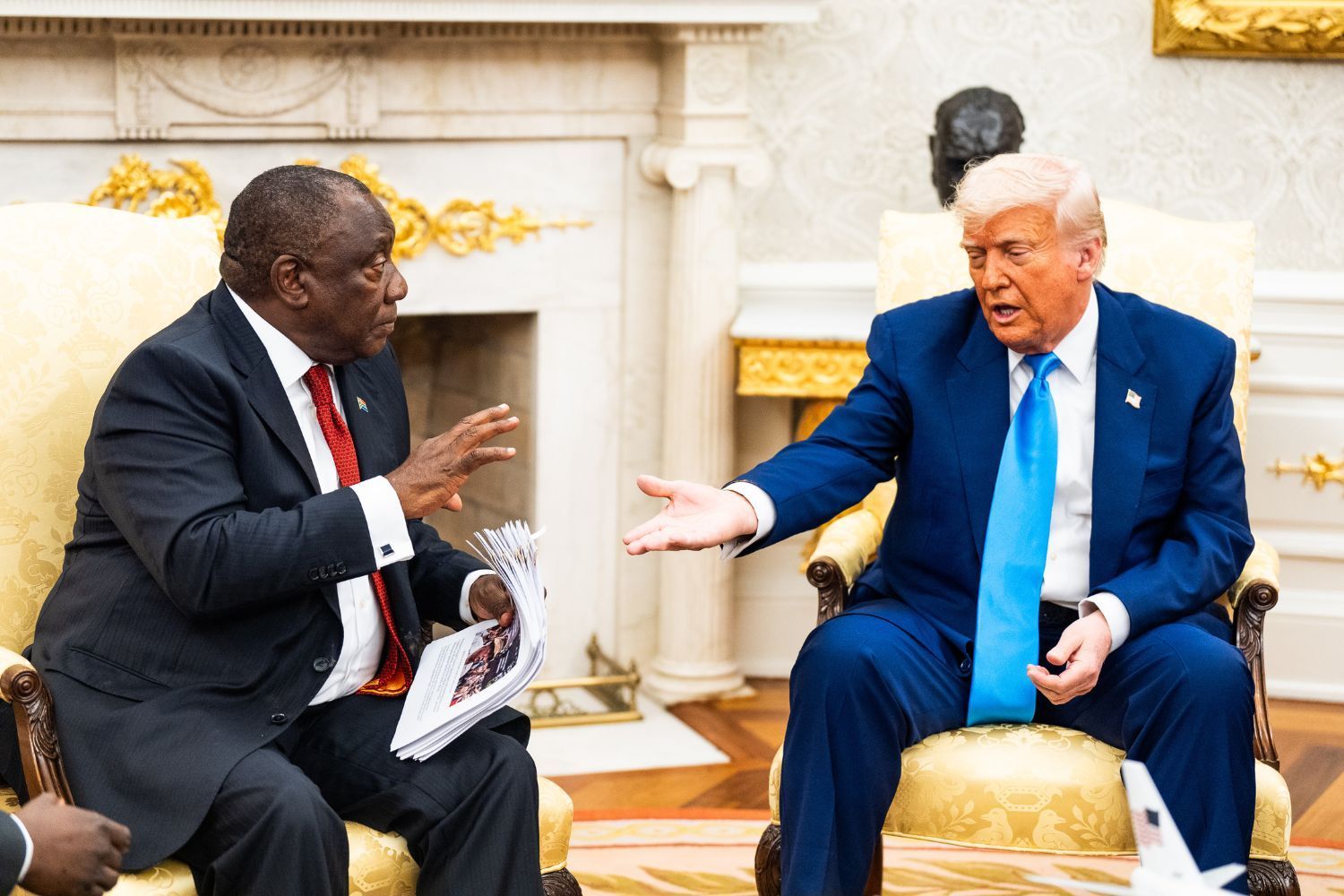 U.S. President Donald Trump gestures towards papers he had present to  President Cyril Ramaphosa during their meeting  in the Oval Office of the White House on Wednesday May 21, 2025.