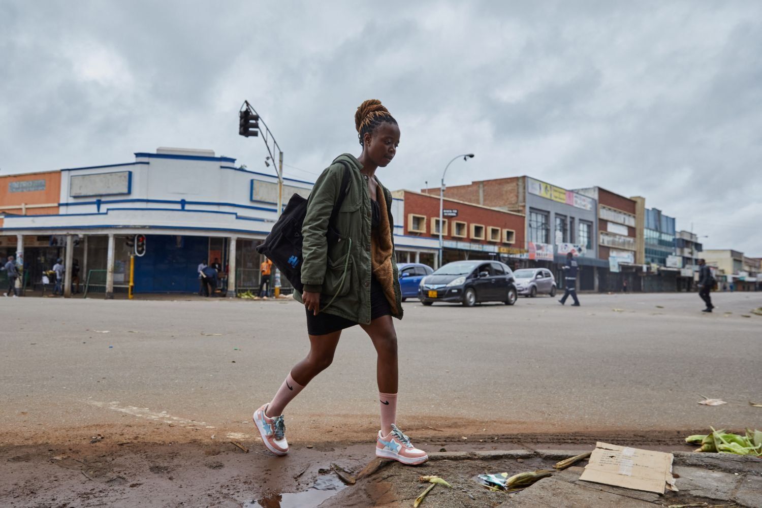 A young woman walks across a largely empty central business district in Harare, Zimbabwe on March 31, 2025, amidst calls for nationwide protest action calling for removal of the country's President.