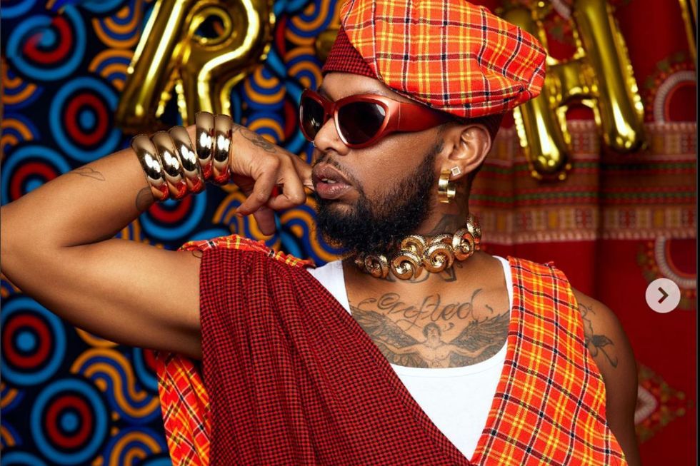 Litchi Hov poses wearing a colourful garment