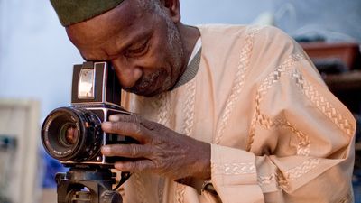 Malick Sidibé with his camera