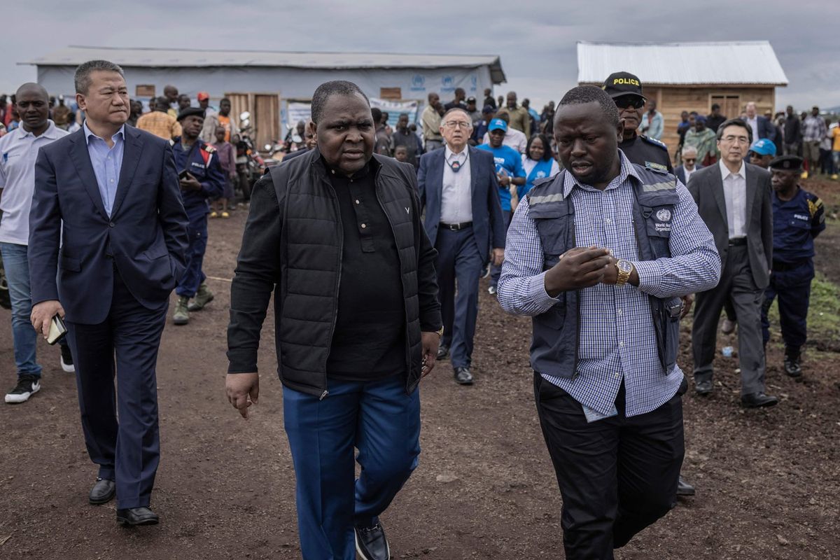 Michel Xavier Obiang (C), Permanent Representative of Gabon for the United Nations talks with a World Health Organization aid worker during the United Nations Security Council visit to the Bushagara camp, north of Goma, on March 12, 2023.