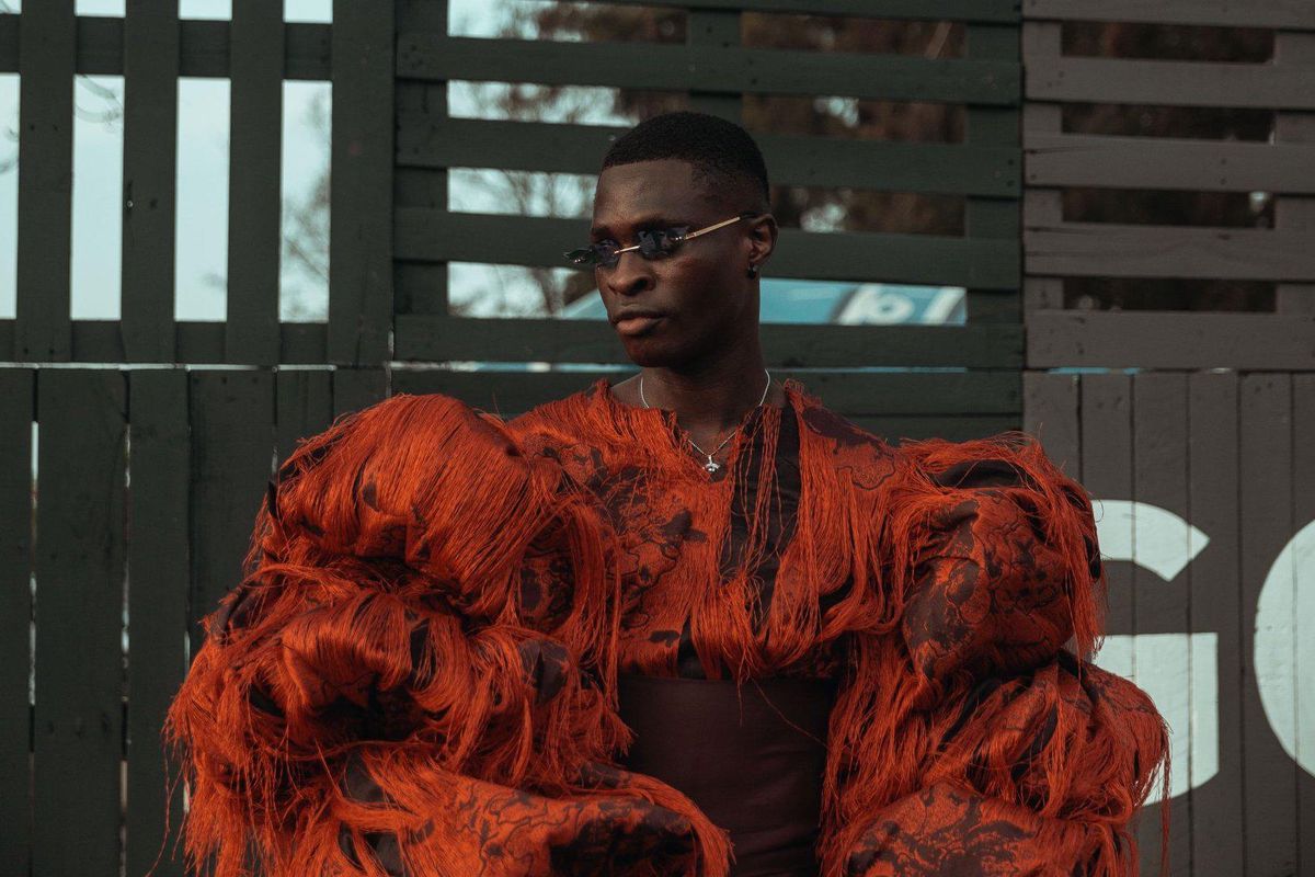 Model wearing orange coat Lagos Fashion Week 2021