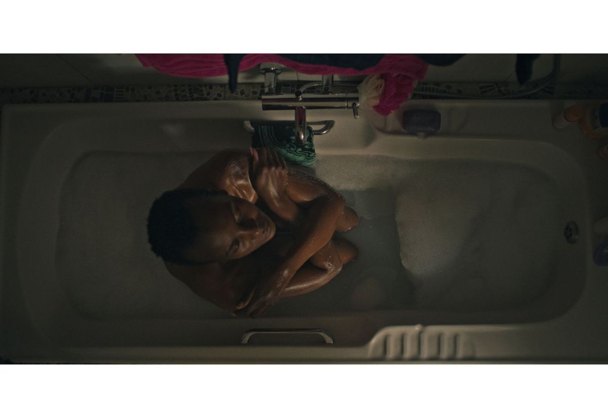 Mona Monyane contemplates her life while sitting in a bathtub