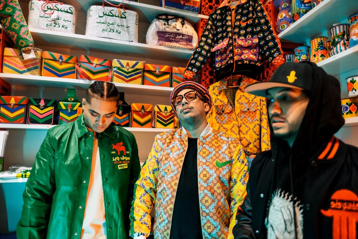 Moroccan rappers Small X, YP, and Di-Meh filmed in Hassan Hajjaj’s store in Marrakech wearing fashionable and brightly colored street clothing.