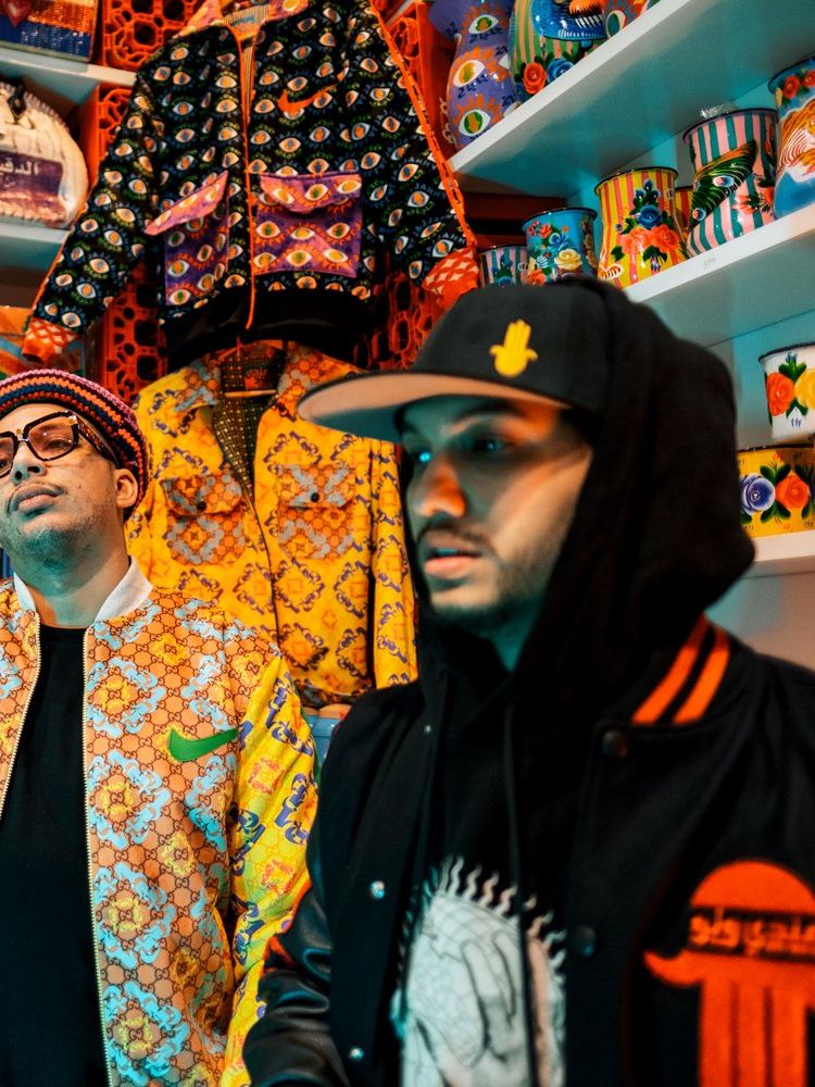 Moroccan rappers Small X, YP, and Di-Meh filmed in Hassan Hajjaj’s store in Marrakech wearing fashionable and brightly colored street clothing.