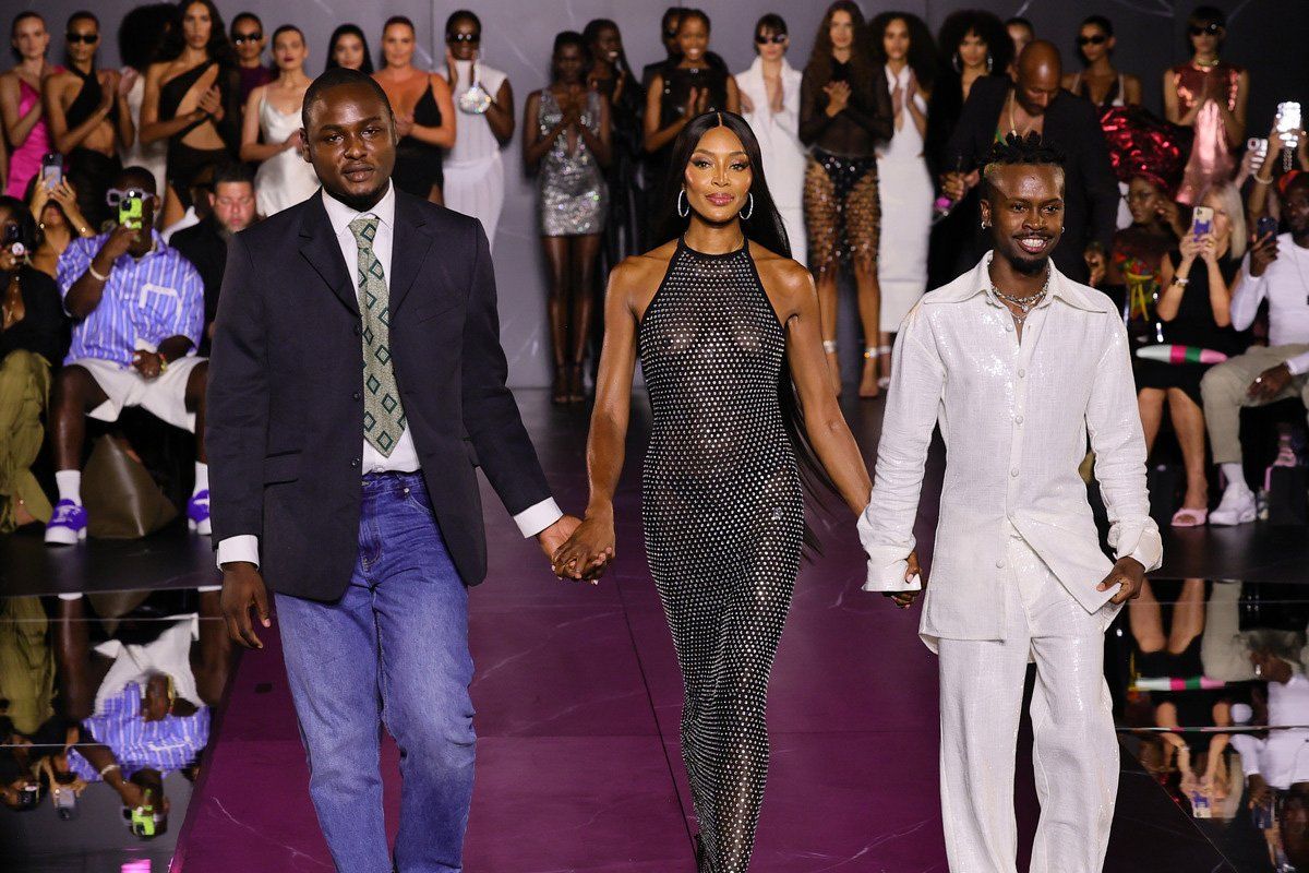 Naomi Campbell taking a final walk on the runway, accompanied by designers Victor Anate (left) and Edvin Thompson (right) for her debut collection for Pretty Little Thing at Cipriani, 25 Broadway on September 05, 2023 in New York City. 