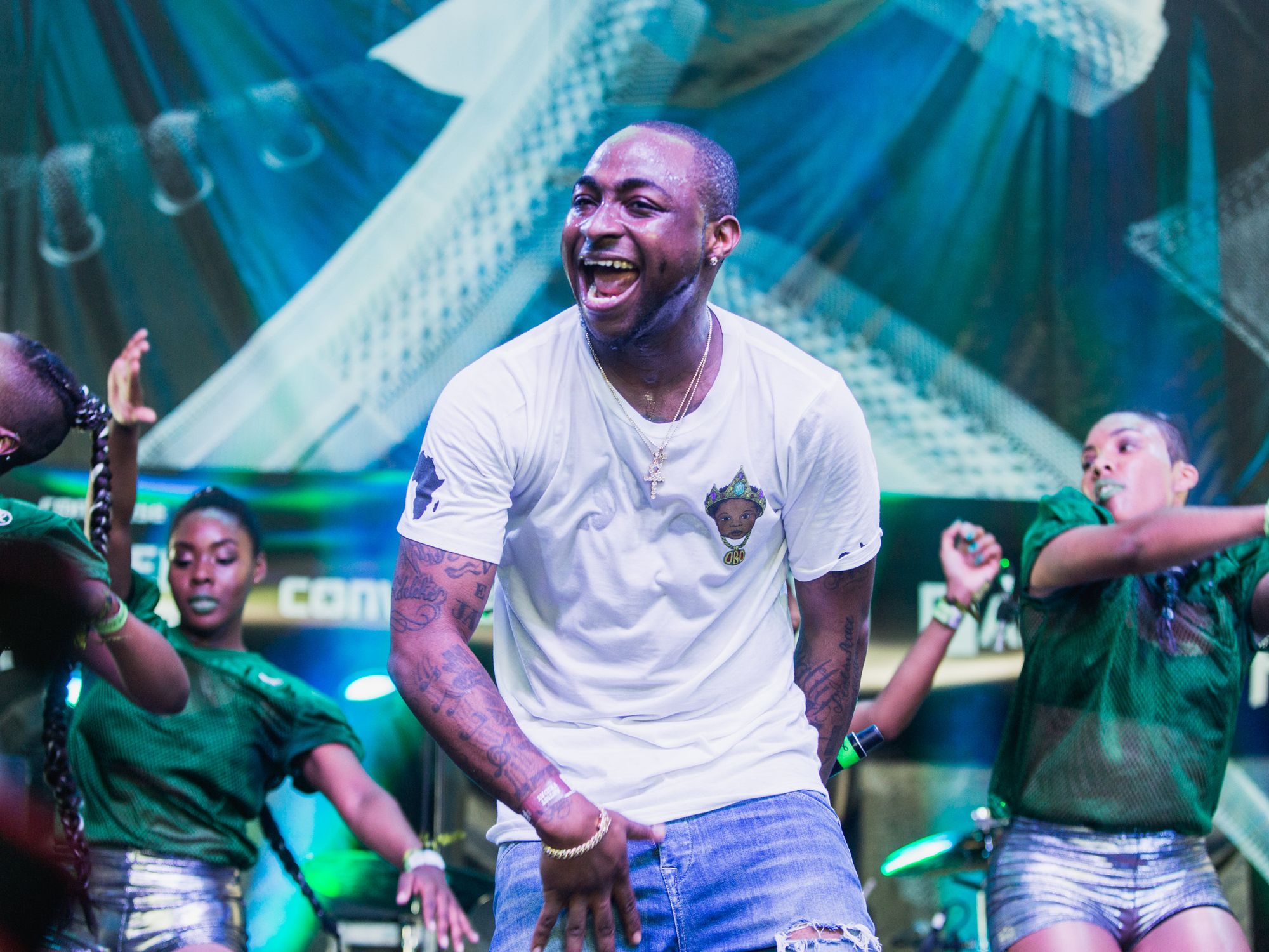 Nigerian Afrobeats Star Davido on stage in white shirt