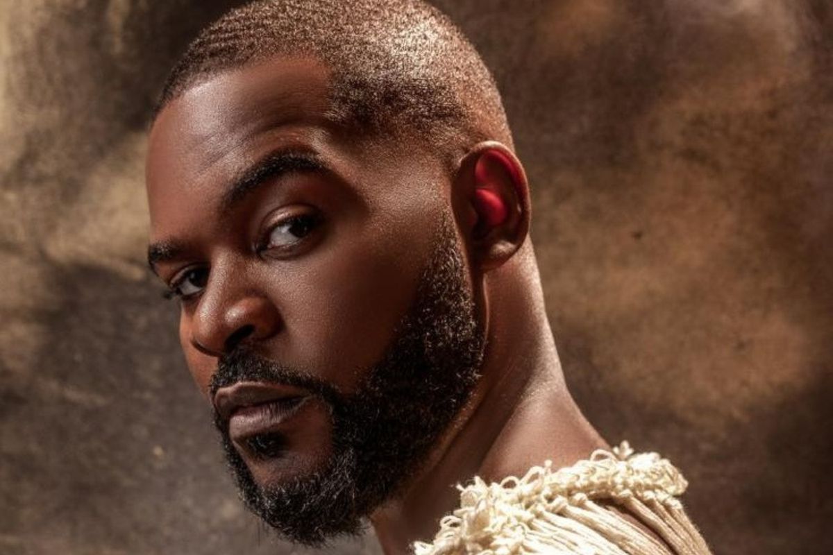 Nigerian artist Falz shot in profile, looking over his shoulder and staring at the camera.