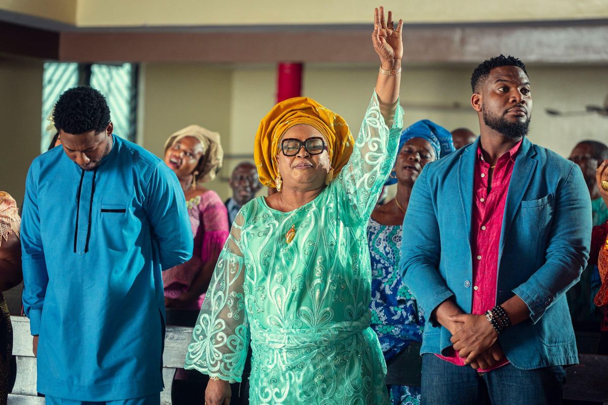 Nigerian man, woman, and man in church from A Naija Christmas.