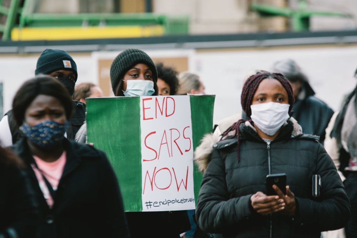Nigerian protestors holding #EndSARS sign