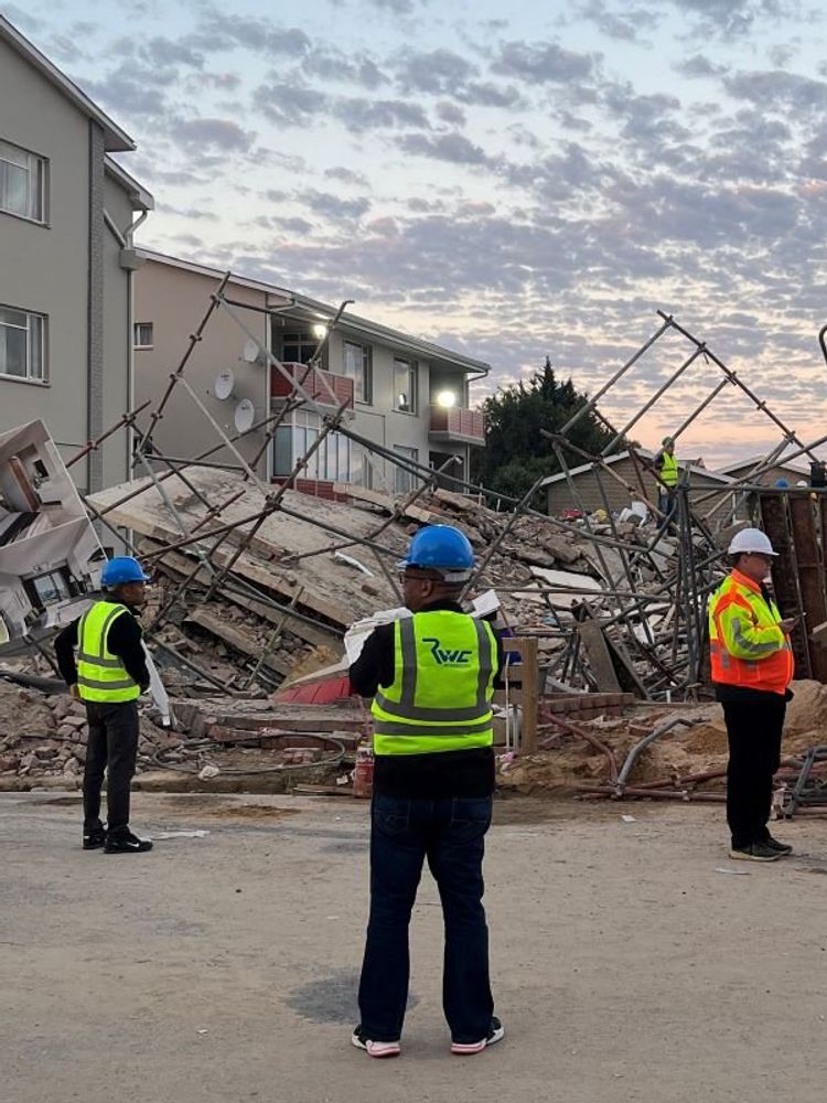 Officials are seen at the scene of a collapsed building in George, South Africa on May 7, 2024. 