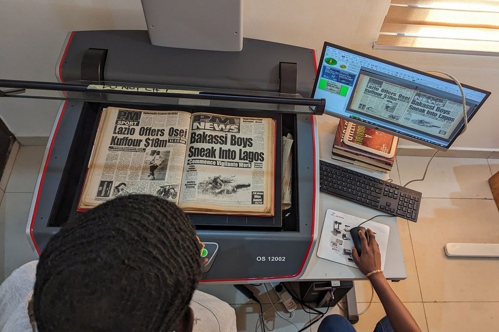 Old newspapers being scanned at the Archivi.ng office.