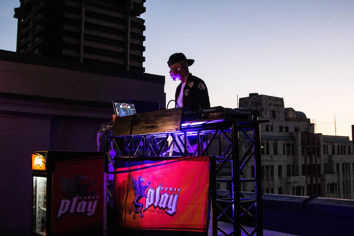 P Kuttah on the decks to a backdrop of a portion of the Joburg skyline. 