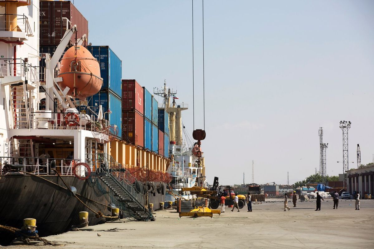 People load up a cargo ship in the Port of Berbera in Somaliland on December 5, 2015. The main exports from Somaliland are livestocks to the Gulf countries like Saudi Arabia, Dubai and Qatar. 
