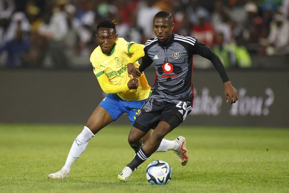 Pirate's South African midfielder #26 Bandile Shandu (R) vies for the ball with Sundowns' South African midfielder #33 Thapelo Maseko (L) during the Premier Soccer League football match between Orlando Pirates and Mamelodi Sundowns at Orlando Stadium in Soweto on September 20, 2023.