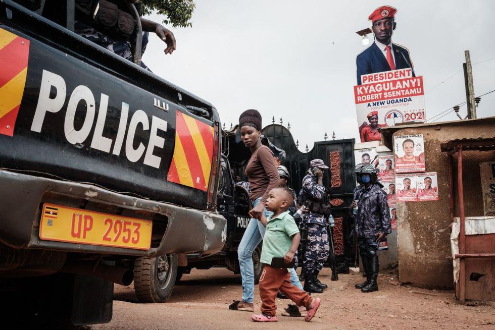 Police officers position at the gate of the headquarters of National Unity Platform (NUP) in Kampala, Uganda, on January 18, 2021.