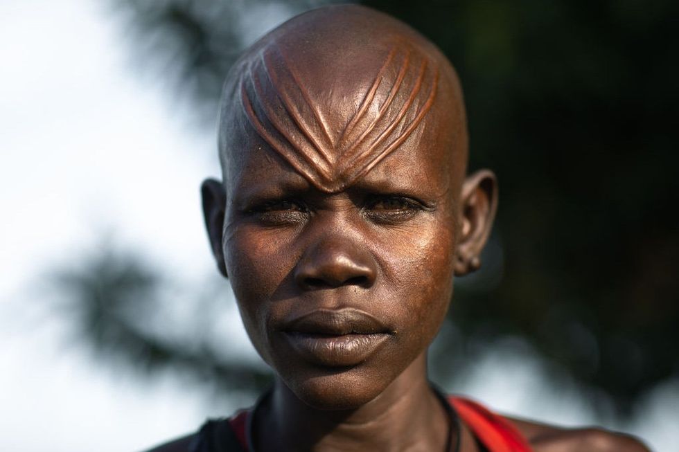 Portrait of a Mundari tribe woman with scarifications on the forehead, Central Equatoria, Terekeka, South Sudan on November 17, 2019 in Terekeka, South Sudan.