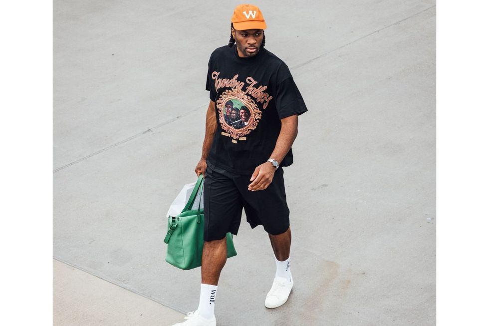 Precious Achiuwa wears a Black t-shirt from Lost Archives and shorts topped off with socks from WafflesnCream