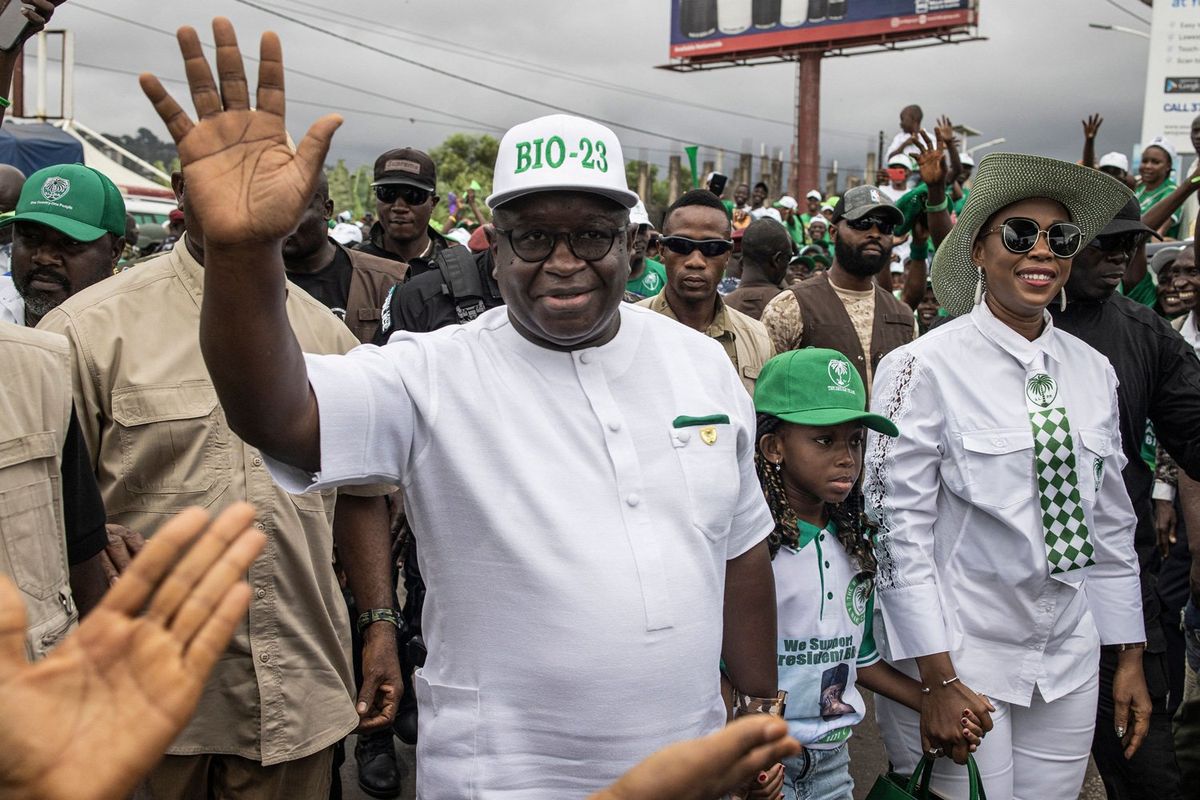President of Sierra Leone and Leader of Sierra Leone People's party (SLPP), Julius Maada Bio (L), waves to his supporters as he arrives for his final campaign rally in Freetown on June 20, 2023. 