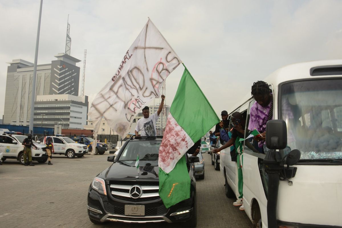Protesters chant slogan songs during a protest to commemorate one year anniversary of #EndSars, a protest against a military attack on protesters at Lekki tollgate in Lagos, Nigeria, on October 20, 2021.