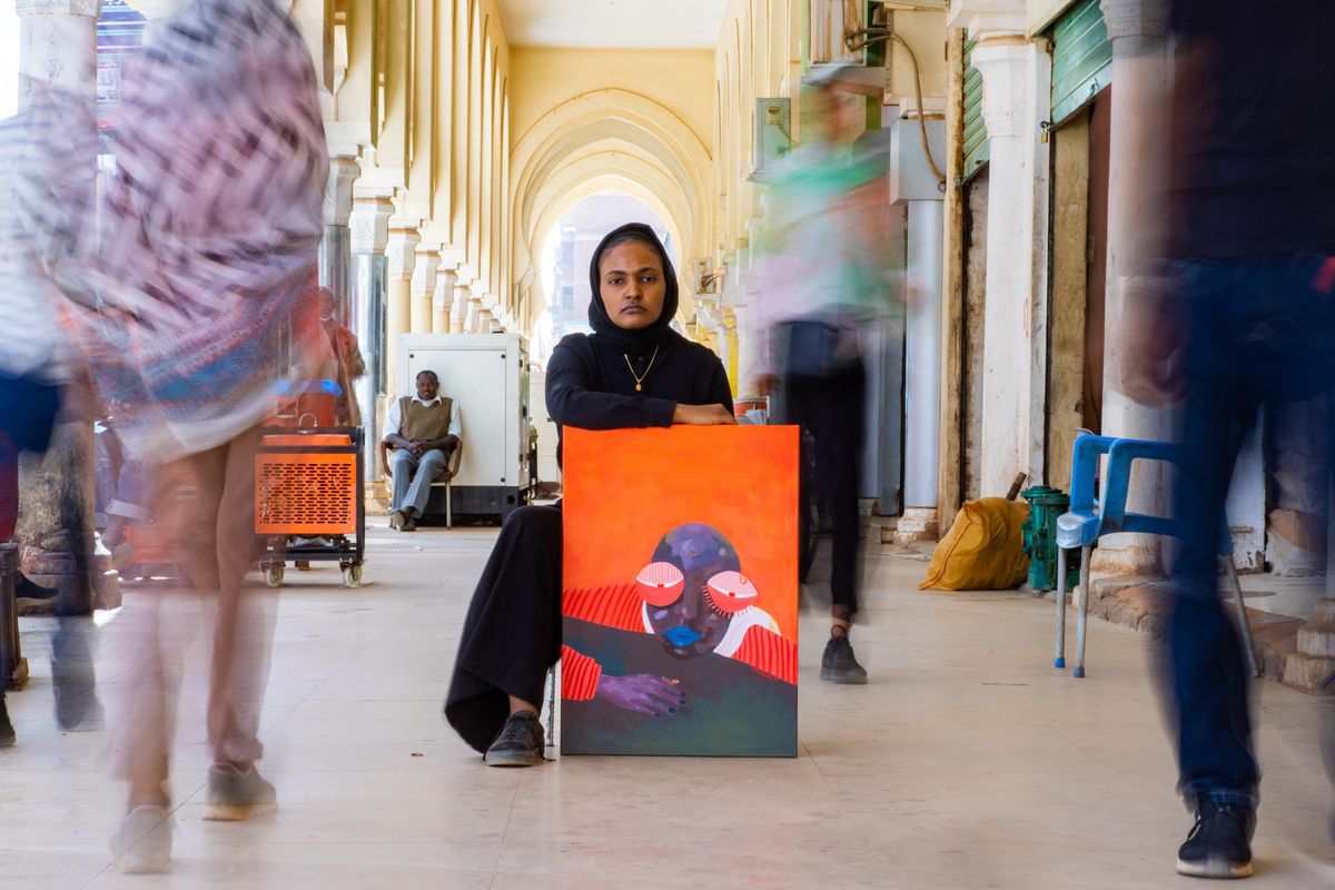 Reem Aljeally with her painting 