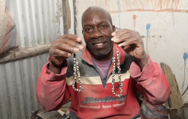 Salmon Odongo displaying products made from bones