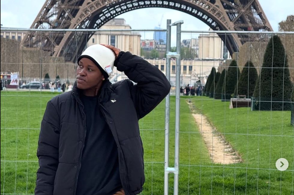 Seyi Oluyole poses in front of the Eiffel Tower