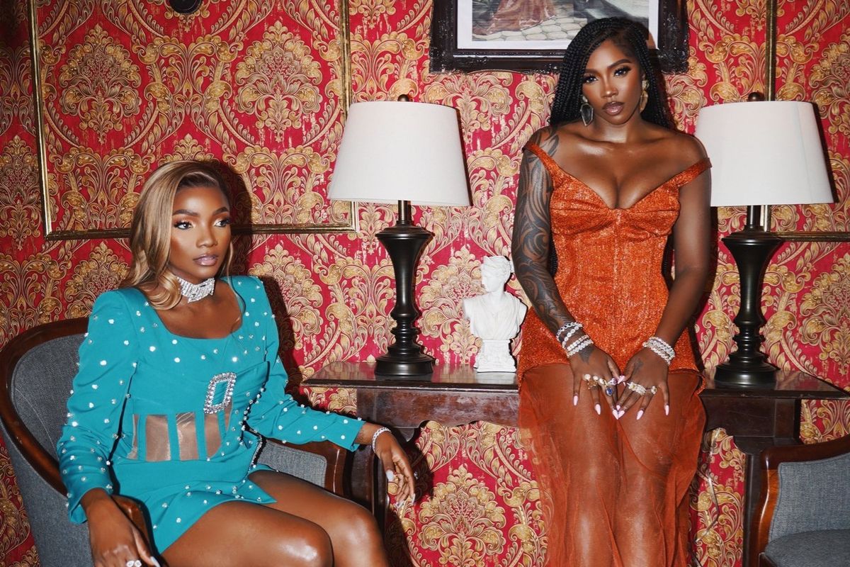 Simi and Tiwa Savage pose in a promotional photo on the set of their single, “Men Are Crazy”.