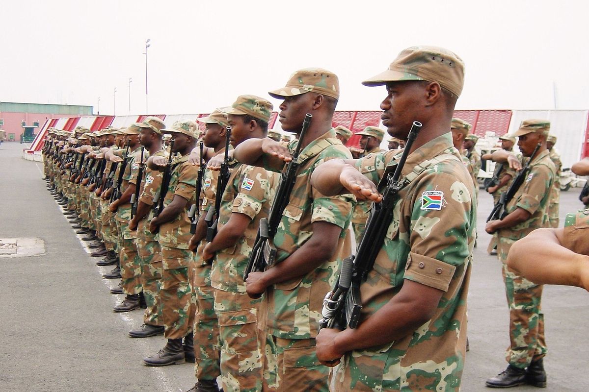 ​South African troops, serving as peacekeepers with the African Union Mission in Burundi salute the arrival of Major General Siphiwe Nyanda, chief of the South African National Defence Force, Bujumbura, Burundi, 27th August 2003