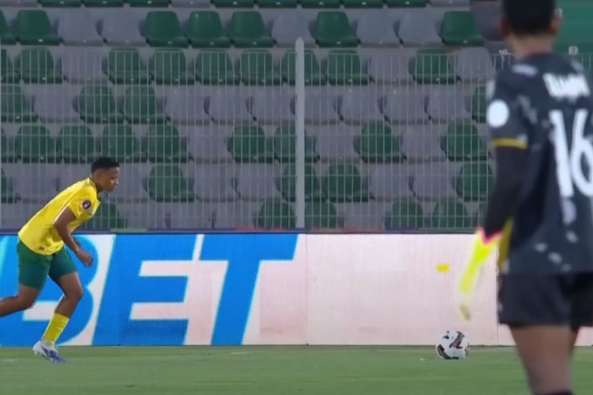 South Africa’s women’s national team captain Refiloe Jane strides towards the ball to hit a free kick. South African goalkeeper Andile Dlamini is in the background.