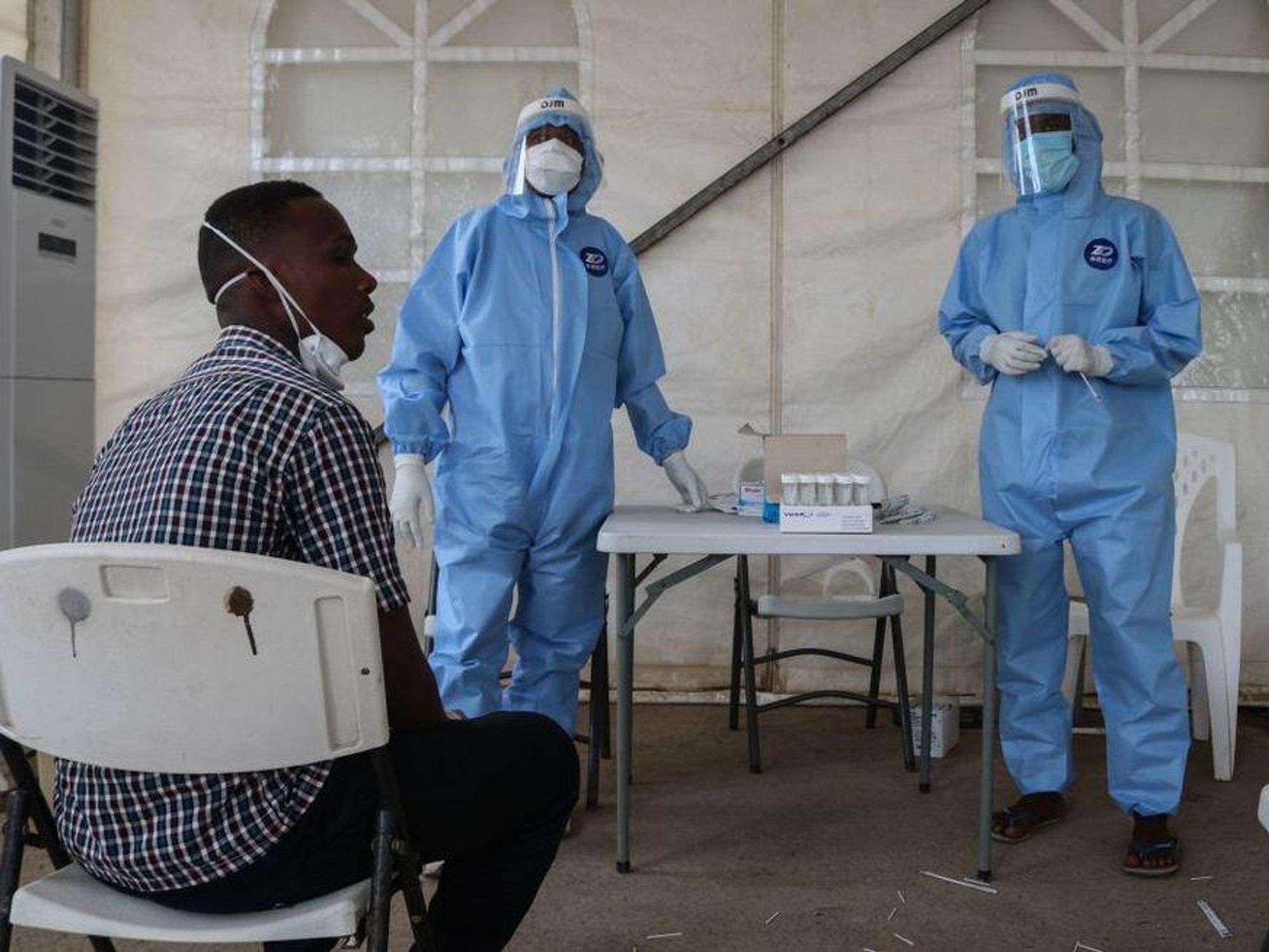 Staff members of the Ministry of Health prepare to take samples for testing for the COVID-19 coronavirus at the testing unit at the Bouffard hospital in Djibouti.
