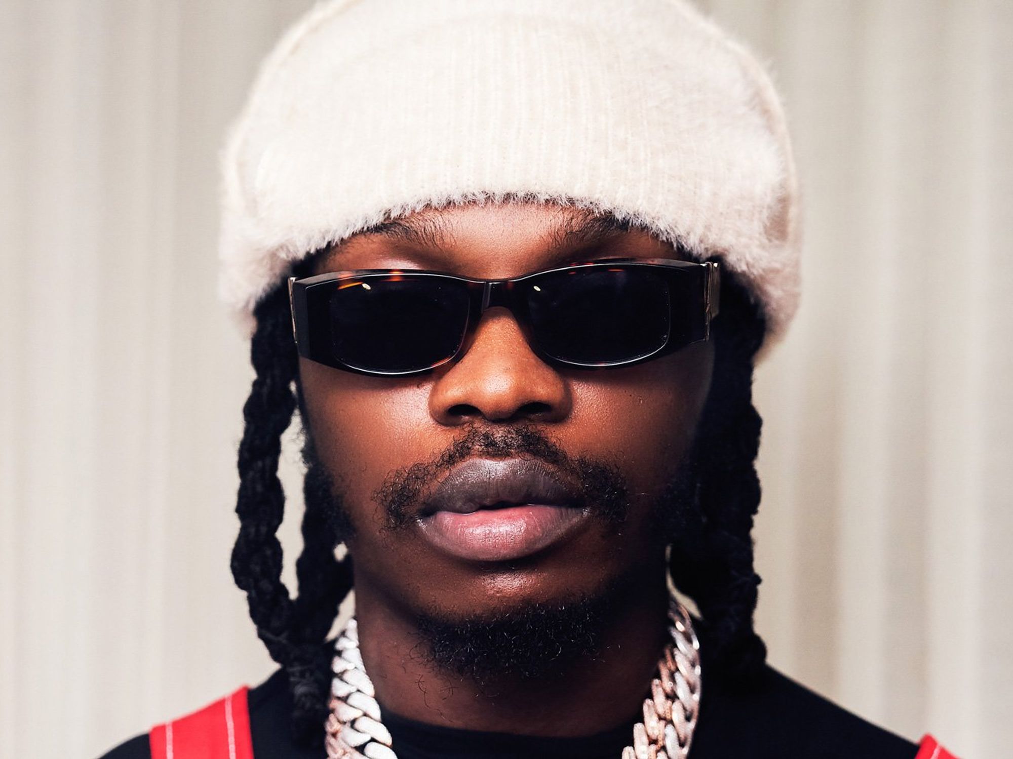 Still shot of Naira Marley with sunglasses and beanie. 