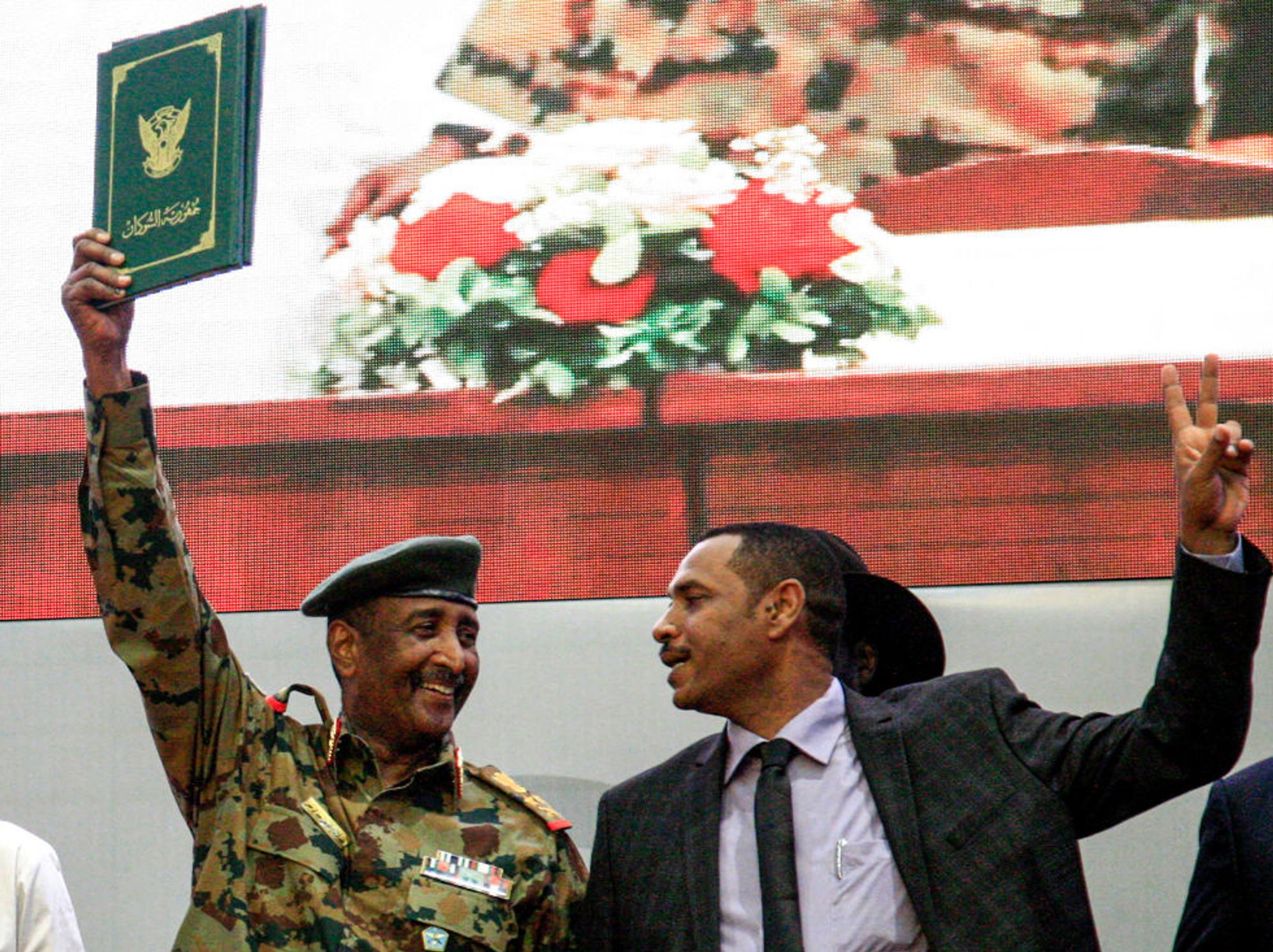 Sudan military man dressed in army uniform waves peace deal 