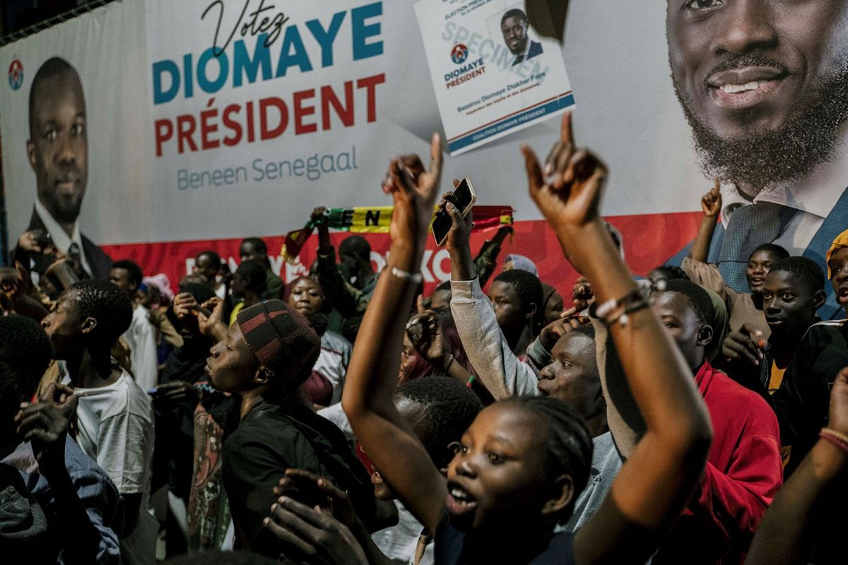 Supporters gather outside anti-establishment candidate Bassirou Diomaye Faye's headquarters in Dakar on March 24, 2024, after voting closed in the presidential election.