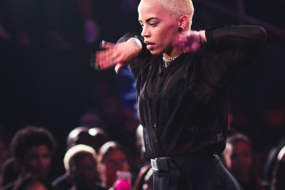 Tarryn Alberts caught in the middle of a dance routine. She is dressed in black clothes and has her hair dyed blonde.