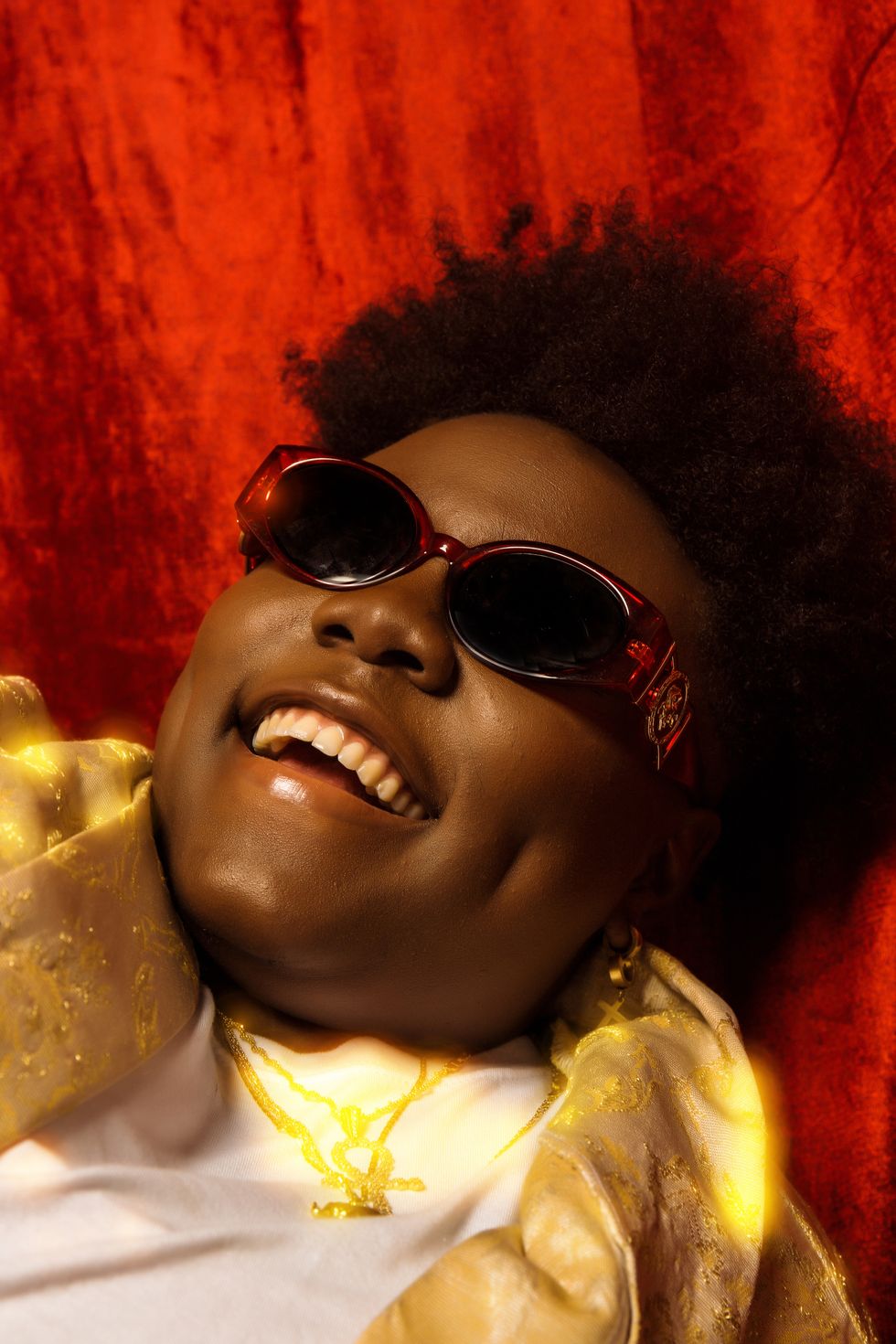 Teni smiles in a close-up portrait shot.