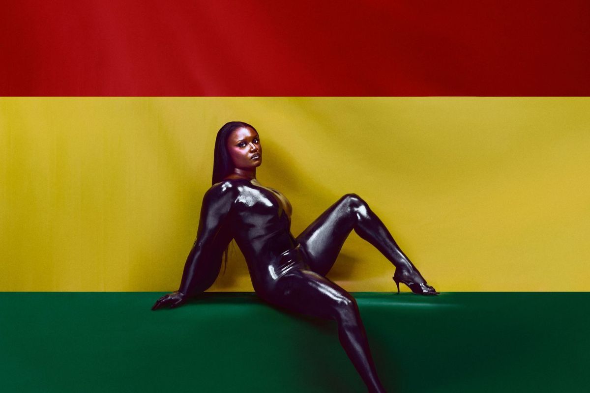 The cover artwork for Amaarae’s new album, Black Star, features the artist in black latex posing in front of a Ghanaian flag.