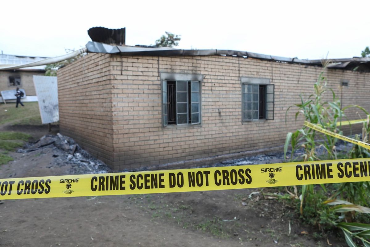 This photo taken on June 18, 2023 shows a tap cordoning off the burnt students' dormitory inside the Lhubiriha Secondary School, in Mpondwe, Uganda. Calm has returned to Mpondwe town in Uganda's southwestern district of Kasese, where the Allied Democratic Forces ADF rebels killed 41 people, most of them students, a government official said Sunday.